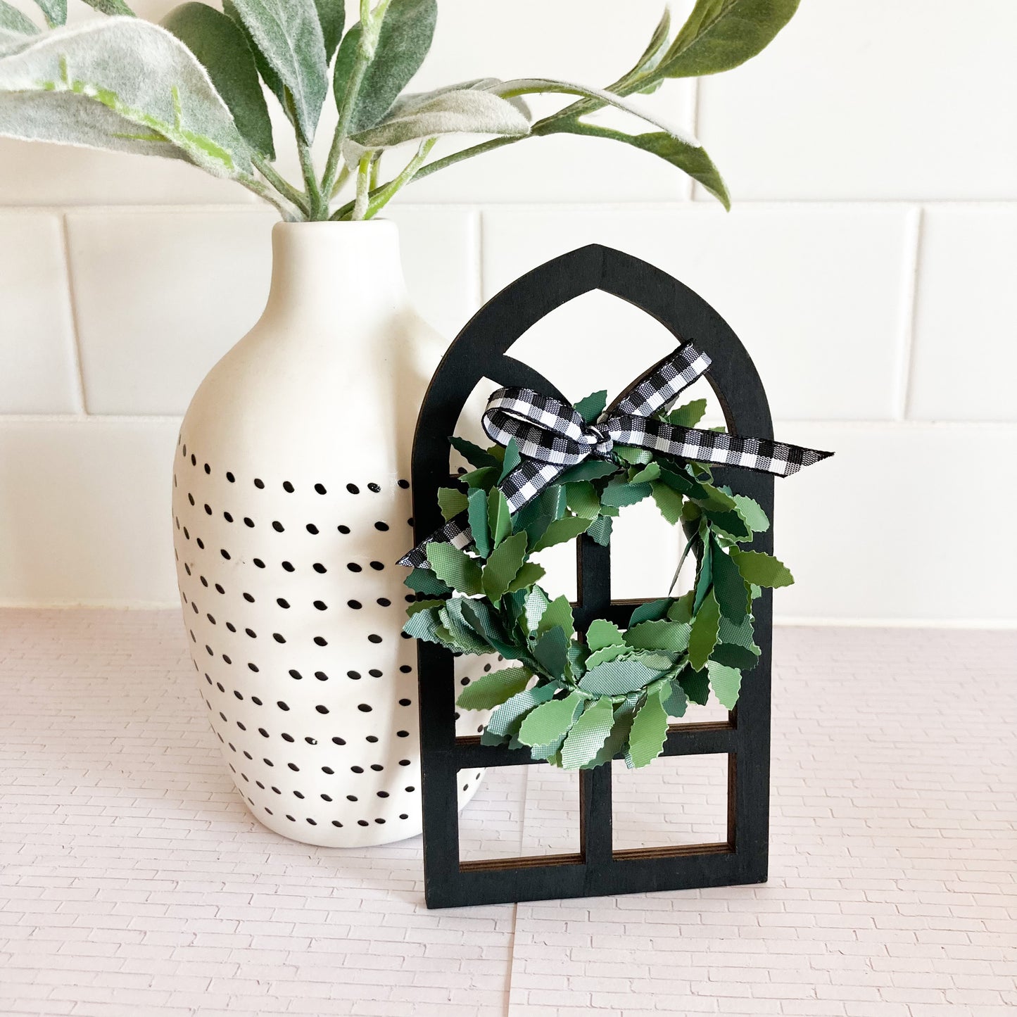 Handmade mini cathedral window shelf sitter 3"x6" 1/4" thick color black decorated with wreath greenery and buffalo checkered bow