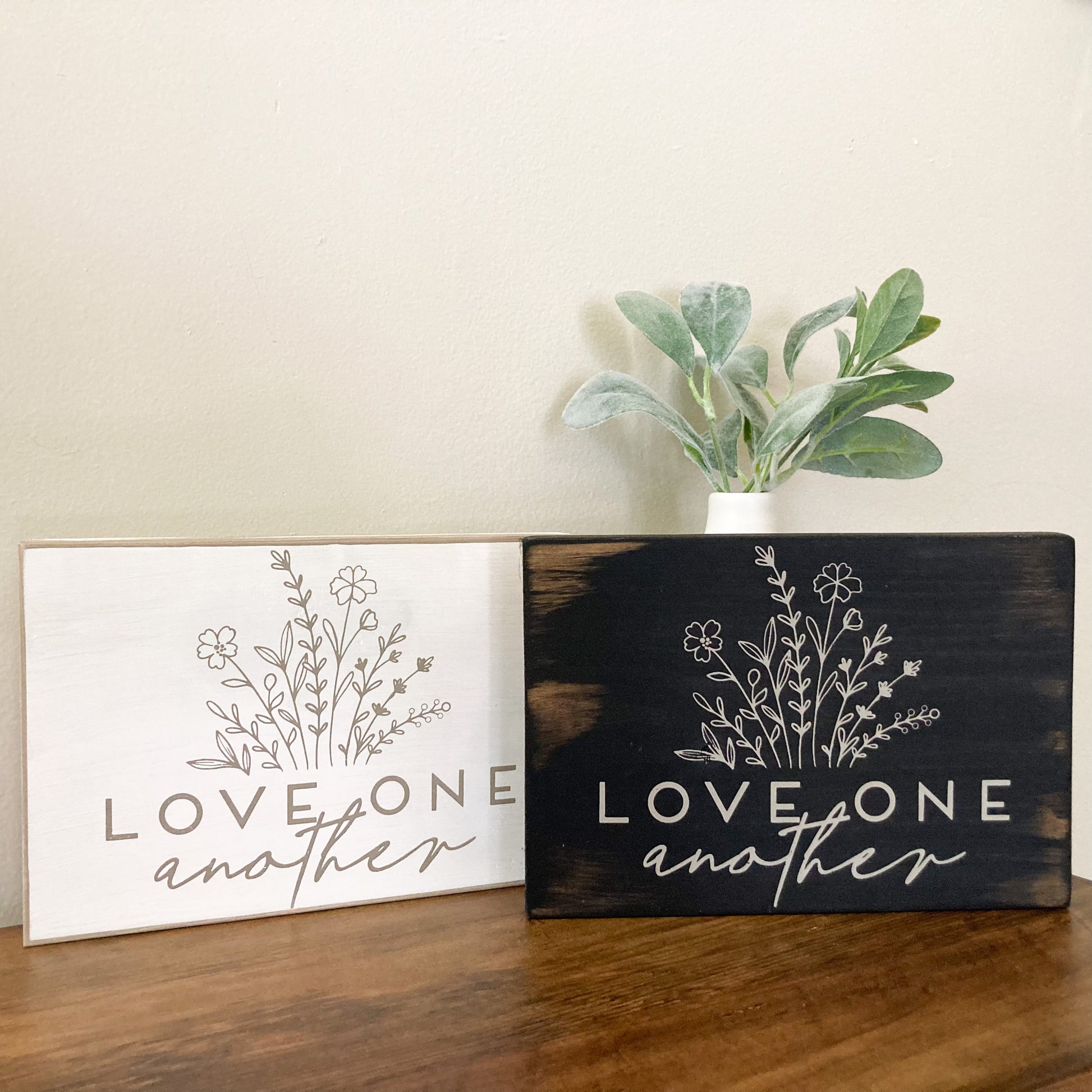 Handmade wood sign painted distressed with flowers and words saying love one another 5.5 inches by 8 inches comes in either black sign or white sign