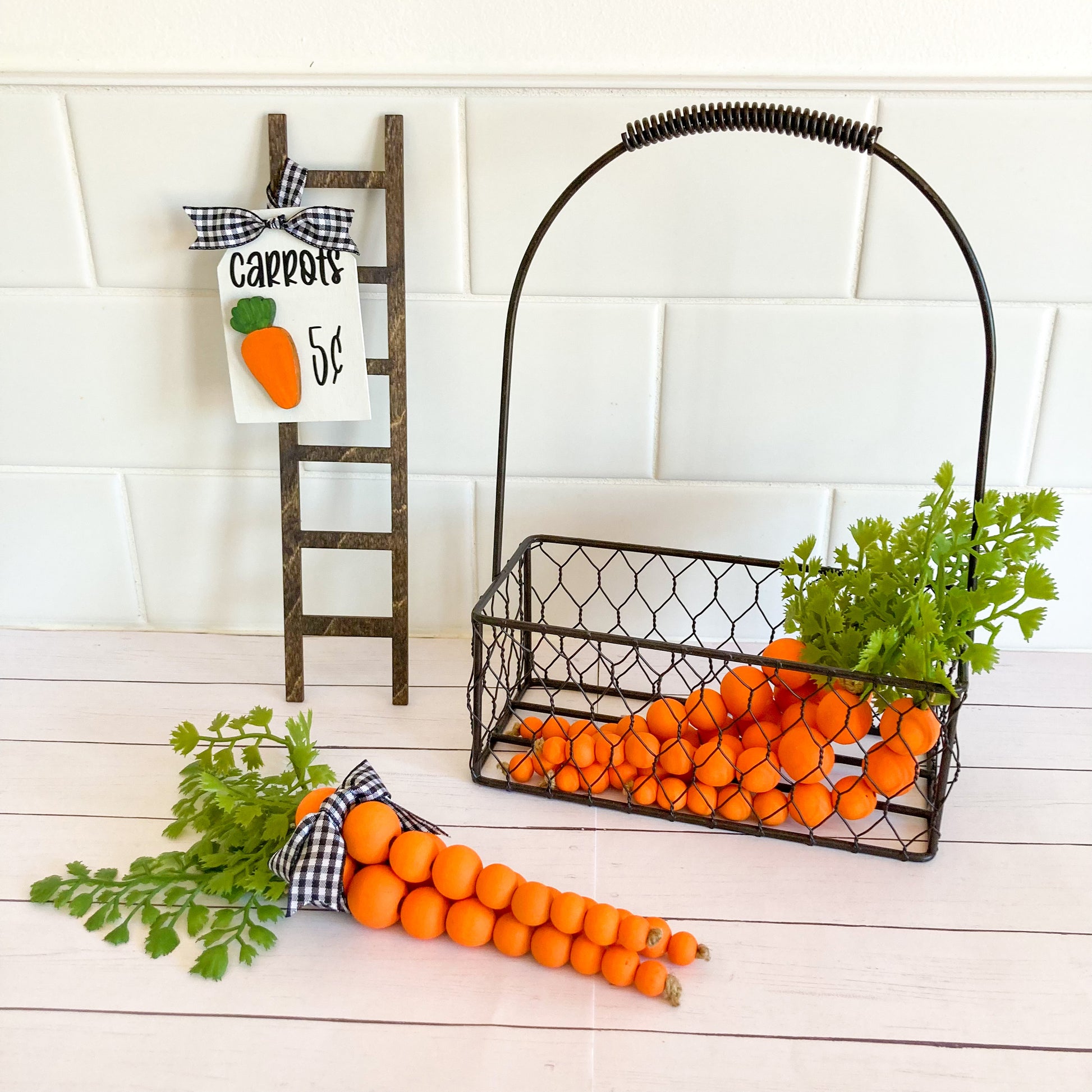 Handmade 3 orange carrot decor bundle each 8" long including 5" of wood beading with 3" faux greenery tied together with a buffalo checkered ribbon