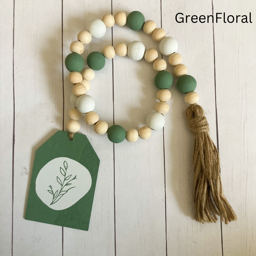 floral wood bead garland hand made from natural wood hand painted green floral vinyl decal with wood green and white beds finished with a tassel