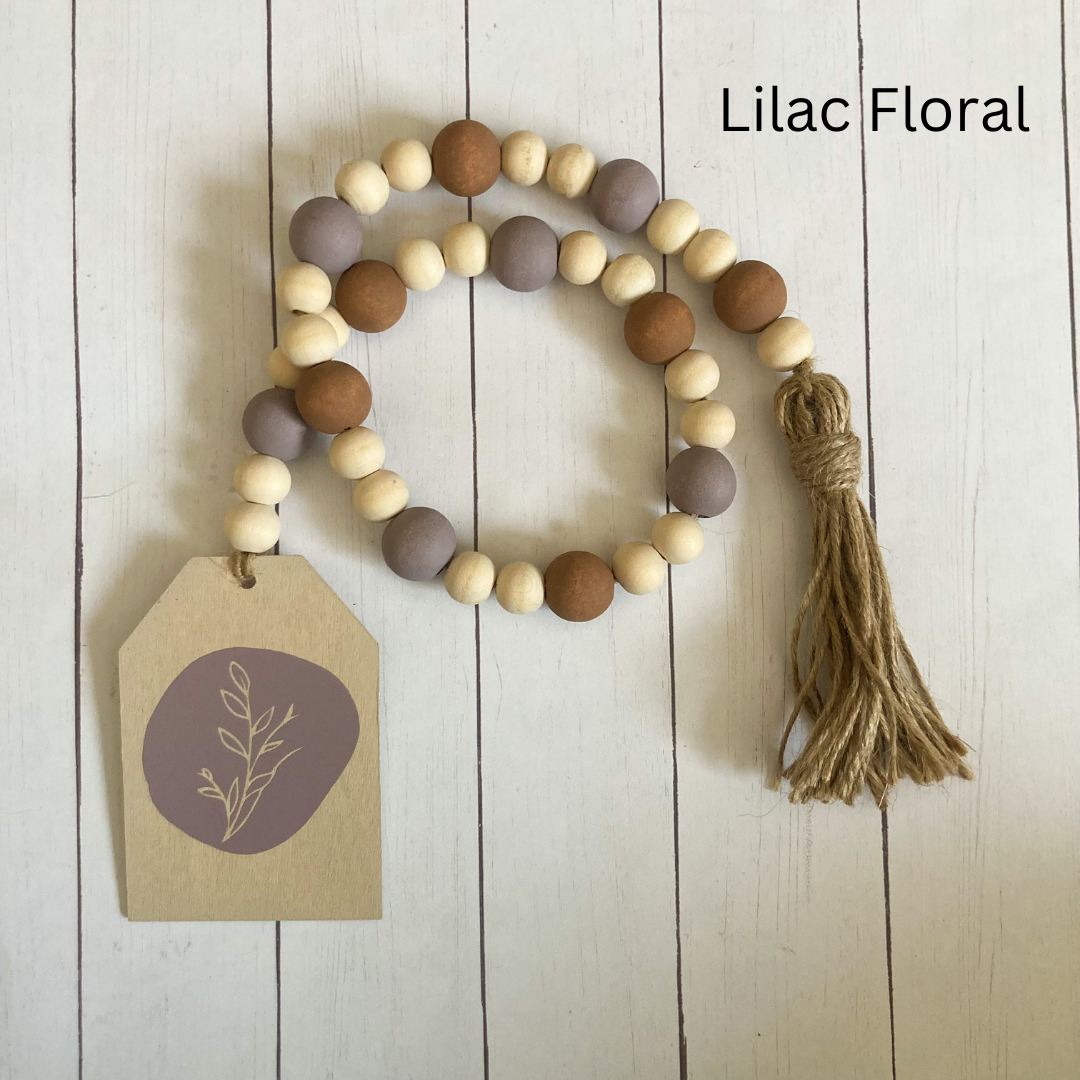 floral wood bead garland hand made from natural wood hand painted purple floral vinyl decal with wood lilac and brown beds finished with a tassel
